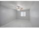 Bedroom featuring tile floors, ceiling fan, and a bright window at 6939 W Cambridge Ave, Phoenix, AZ 85035