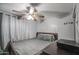 Bedroom featuring a bed, ceiling fan, and curtained window at 6939 W Cambridge Ave, Phoenix, AZ 85035