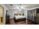 The bedroom has a complete bed set, hardwood floors, and a neutral color scheme, promoting relaxation at 6939 W Cambridge Ave, Phoenix, AZ 85035