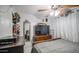 Bedroom with bed, dresser, ceiling fan, and large TV at 6939 W Cambridge Ave, Phoenix, AZ 85035