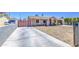 Wide driveway leading to a cozy single-story home with xeriscaped front yard at 6939 W Cambridge Ave, Phoenix, AZ 85035