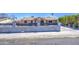 View of the home from the street with a concrete fence and wrought iron gate at 6939 W Cambridge Ave, Phoenix, AZ 85035