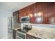 Well-appointed kitchen boasts stainless steel appliances and granite countertops at 6939 W Cambridge Ave, Phoenix, AZ 85035