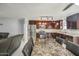 A spacious kitchen with stainless steel appliances, granite countertops, and an adjacent dining area at 6939 W Cambridge Ave, Phoenix, AZ 85035