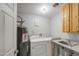 Laundry room featuring a washing machine, dryer, and utility sink at 6939 W Cambridge Ave, Phoenix, AZ 85035