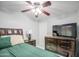 Comfortable main bedroom featuring a wooden bed set and TV at 6939 W Cambridge Ave, Phoenix, AZ 85035
