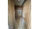 Narrow hallway featuring linoleum floors and wood paneled walls at 7214 S 42Nd St, Phoenix, AZ 85042