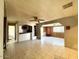 Open living room featuring ceiling fan, tile floors, and direct access to the kitchen at 7214 S 42Nd St, Phoenix, AZ 85042