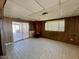 Living room featuring a unique vintage fireplace, wood paneled walls and tile flooring at 7214 S 42Nd St, Phoenix, AZ 85042