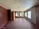 A living room featuring linoleum floors, wood paneled walls and natural light from exterior windows at 7214 S 42Nd St, Phoenix, AZ 85042