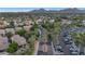 Expansive aerial view of a neighborhood with lush trees, palm-lined streets, and mountain views at 7438 E San Jacinto Dr, Scottsdale, AZ 85258
