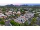 Scenic aerial view of a residential neighborhood nestled amidst lush greenery and mountain views at 7438 E San Jacinto Dr, Scottsdale, AZ 85258