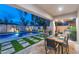 Inviting backyard pool with lush landscaping and outdoor dining area, perfect for entertaining guests at 7438 E San Jacinto Dr, Scottsdale, AZ 85258
