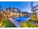 Inviting backyard with a sparkling pool, lounge area, and lush landscaping, perfect for outdoor entertaining at 7438 E San Jacinto Dr, Scottsdale, AZ 85258