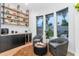 Chic bar area with open shelving, a wine cooler, comfortable seating, and natural light at 7438 E San Jacinto Dr, Scottsdale, AZ 85258