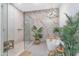 A serene bathroom features a soaking tub, glass-enclosed shower, and contemporary design at 7438 E San Jacinto Dr, Scottsdale, AZ 85258