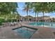 Inviting community pool and spa area surrounded by comfortable seating and lush landscaping at 7438 E San Jacinto Dr, Scottsdale, AZ 85258