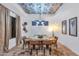 Elegant dining room showcasing a unique ceiling design, modern lighting, and a stylish table set for a meal at 7438 E San Jacinto Dr, Scottsdale, AZ 85258