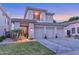 Stunning two-story home with a three-car garage and meticulously manicured front yard at 7438 E San Jacinto Dr, Scottsdale, AZ 85258