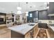 Elegant kitchen boasts a large island with a marble countertop and modern pendant lighting at 7438 E San Jacinto Dr, Scottsdale, AZ 85258