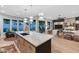 Open-concept kitchen with island seating, flows seamlessly into the living area, creating an inviting space at 7438 E San Jacinto Dr, Scottsdale, AZ 85258