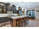 Stylish kitchen featuring a spacious island with seating, modern lighting fixtures, and sleek cabinetry at 7438 E San Jacinto Dr, Scottsdale, AZ 85258