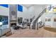 Spacious living room with staircase, fireplace, and soaring ceilings, creating an airy atmosphere at 7438 E San Jacinto Dr, Scottsdale, AZ 85258