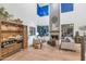 Open-concept living room with a fireplace, bar area, and comfortable seating, ideal for entertaining at 7438 E San Jacinto Dr, Scottsdale, AZ 85258