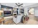 Comfortable living area featuring a modern fireplace, plush seating, and hardwood floors at 7438 E San Jacinto Dr, Scottsdale, AZ 85258