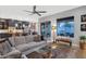 Open concept living room with a large sectional couch and access to the outdoor patio at 7438 E San Jacinto Dr, Scottsdale, AZ 85258