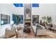 Bright living room with high ceilings, fireplace, and large windows offering plenty of natural light at 7438 E San Jacinto Dr, Scottsdale, AZ 85258