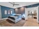 Stylish primary bedroom features a decorative accent wall, a ceiling fan, and a serene ambiance at 7438 E San Jacinto Dr, Scottsdale, AZ 85258