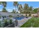 Inviting backyard pool with a lounge area, lush greenery, and serene ambiance perfect for relaxation at 7438 E San Jacinto Dr, Scottsdale, AZ 85258