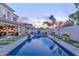 Beautiful backyard showcasing a pristine pool, manicured lawn, and comfortable outdoor seating for entertaining at 7438 E San Jacinto Dr, Scottsdale, AZ 85258