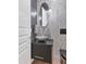 Chic powder room with an eye-catching vessel sink, decorative wall tiles, and contemporary lighting at 7438 E San Jacinto Dr, Scottsdale, AZ 85258