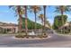 Beautiful street lined with mature palm trees and a decorative water feature in the roundabout at 7438 E San Jacinto Dr, Scottsdale, AZ 85258