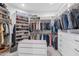 Spacious walk-in closet with custom shelving, drawers, and ample storage space at 7438 E San Jacinto Dr, Scottsdale, AZ 85258