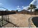 Spacious back yard featuring a block fence, palm tree, and potential for landscaping at 7664 W Vermont Ave, Glendale, AZ 85303