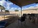 Covered backyard patio featuring a trampoline, chairs, and grill at 7664 W Vermont Ave, Glendale, AZ 85303