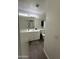 Bathroom features a vanity with a sink, wood-look flooring, and a toilet at 7664 W Vermont Ave, Glendale, AZ 85303