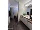 Bathroom featuring wood-look floors and a double sink vanity at 7664 W Vermont Ave, Glendale, AZ 85303