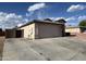 Home exterior featuring a spacious driveway leading to a two-car garage at 7664 W Vermont Ave, Glendale, AZ 85303