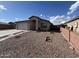 Single-story home featuring desert landscaping, neutral stucco exterior, and an attached two-car garage at 7664 W Vermont Ave, Glendale, AZ 85303