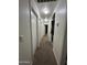 A long hallway with multiple doors and lighting fixtures at 7664 W Vermont Ave, Glendale, AZ 85303