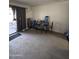 Living Room with sliding glass doors, lots of light, and neutral colored carpet at 7664 W Vermont Ave, Glendale, AZ 85303