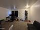 Living room with carpet flooring and shoe rack at 7664 W Vermont Ave, Glendale, AZ 85303