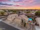 An aerial view showcases the home's location within the community, with a vibrant pool and a picturesque sunset at 780 S Lagoon Dr, Gilbert, AZ 85233
