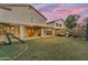 Lush backyard with an extensive patio, playground set, and spacious grass area at 780 S Lagoon Dr, Gilbert, AZ 85233