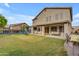 Expansive backyard featuring a covered patio, lush lawn, pool, and playset at 780 S Lagoon Dr, Gilbert, AZ 85233