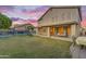 Expansive backyard featuring a covered patio, lush lawn, a swing set, and a sparkling pool, ideal for entertainment at 780 S Lagoon Dr, Gilbert, AZ 85233
